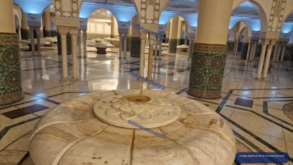 Ornate marble fountain beneath arches in a tiled interior — Casablanca, Morocco