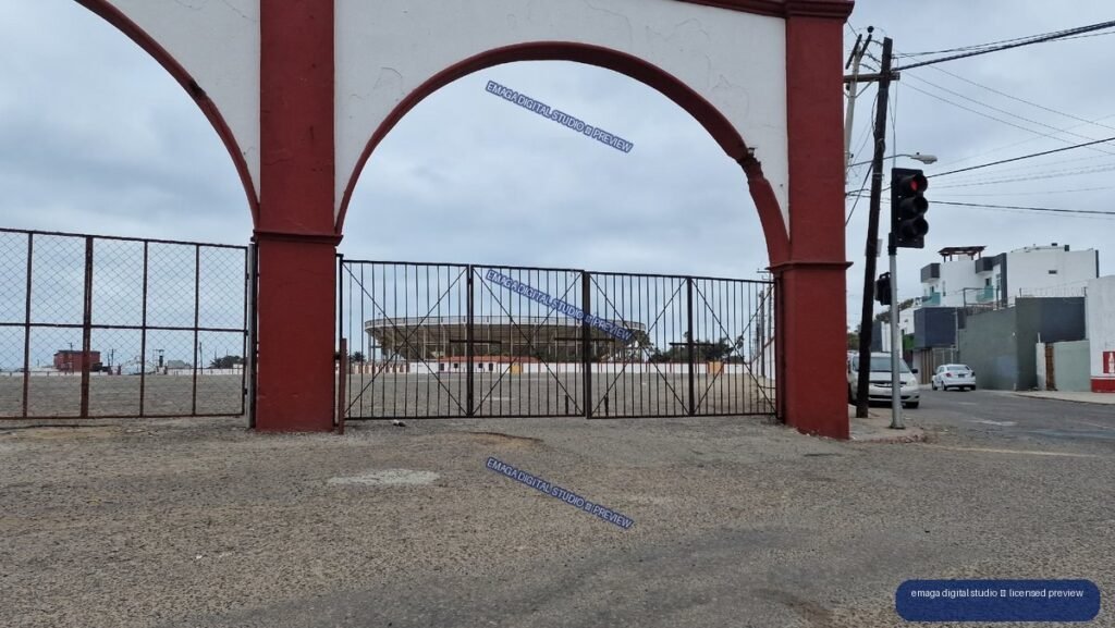 Red Arched Entrance to an Urban Sports Field Under Overcast Skies — Tijuana, Mexico