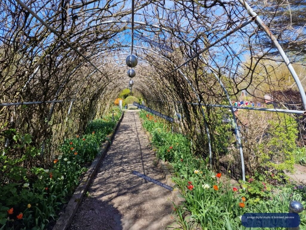Garden Tunnel with Spring Flowers at Hortulus Gardens, Dobrzyca, Poland