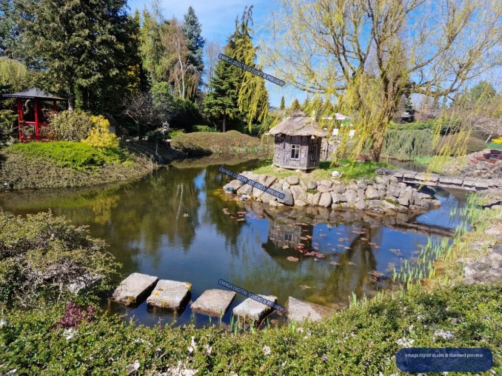 Japanese-style garden pond with rustic hut and stepping stones