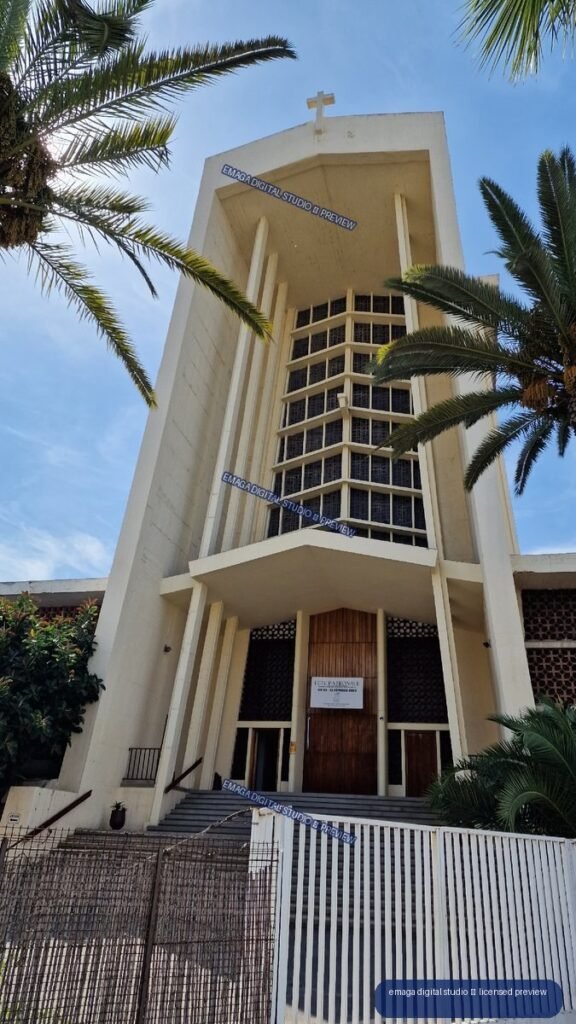 Low-angle view of a white modern church framed by palm trees — Casablanca, Morocco