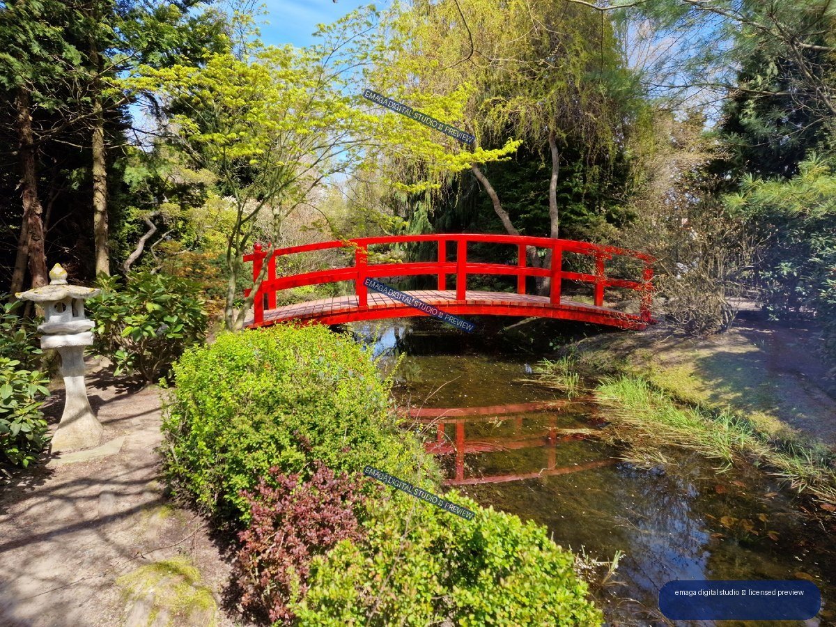 Red Arched Footbridge Over a Reflective Garden Pond — Hortulus Gardens, Dobrzyca