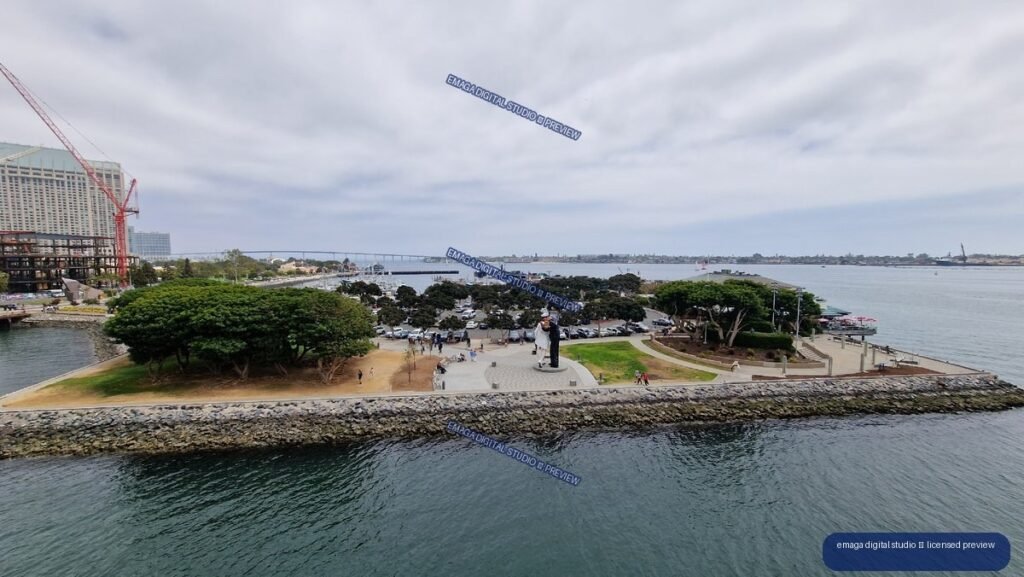 Waterfront park and harbor viewed across calm coastal water — USS Midway, San Diego