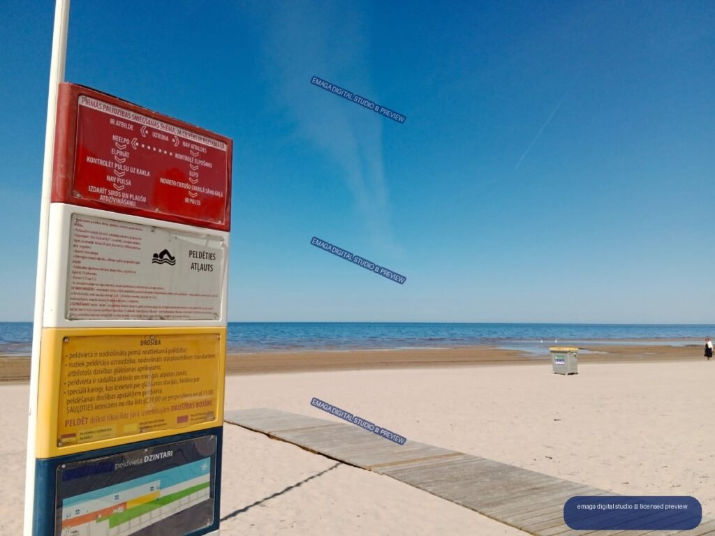Beach safety information sign and boardwalk in Jurmala, Latvia