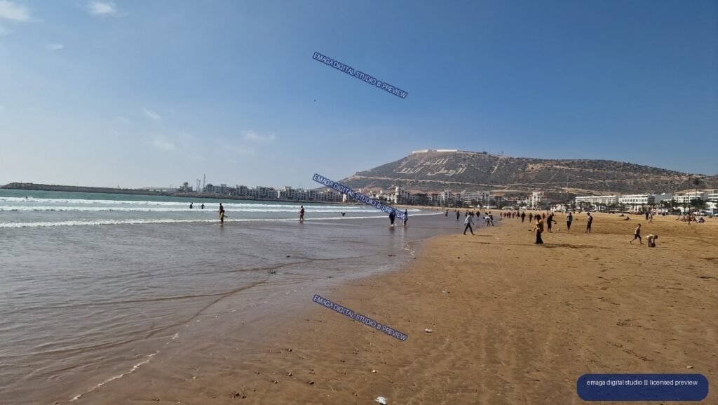 Agadir, Morocco Beachfront with Swimmers and Coastal Hills