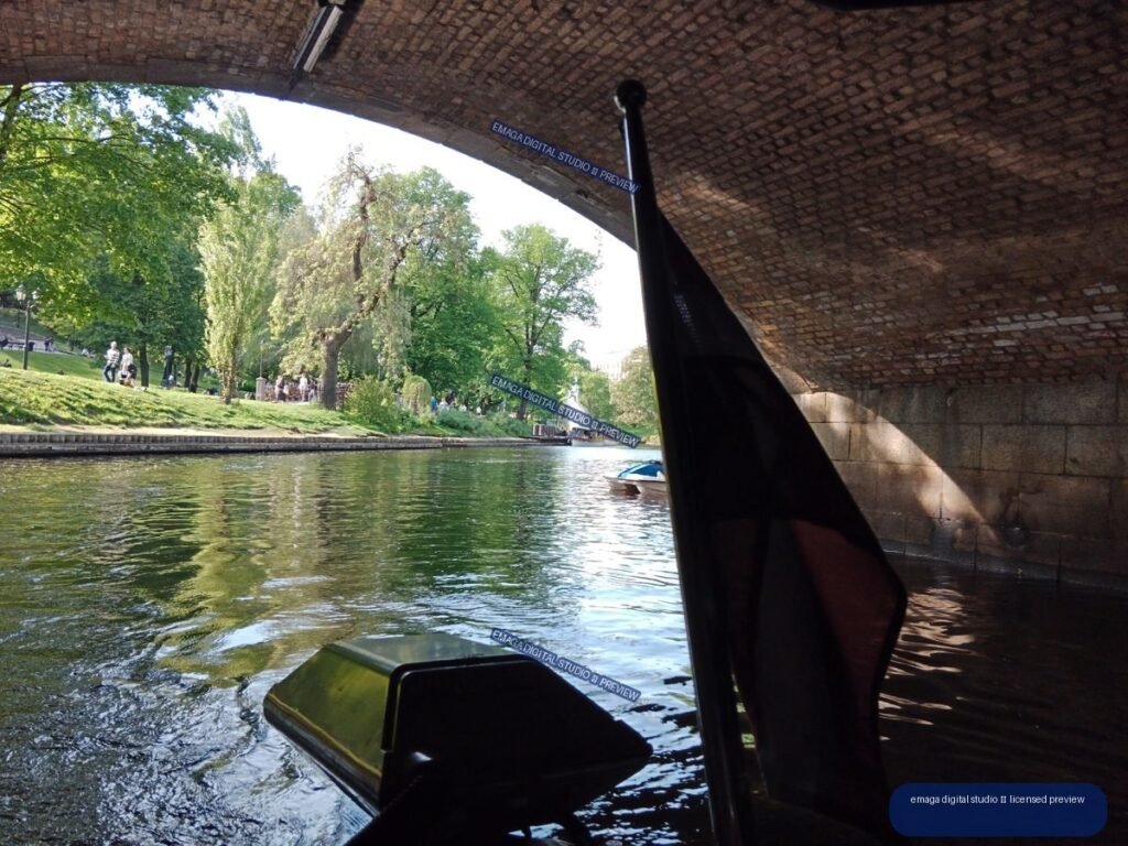 Canal view beneath a brick bridge in Riga, Latvia