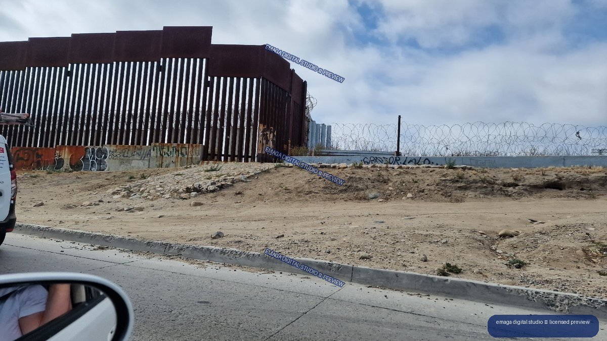 Tall Security Fence and Barbed Wire in Tijuana, Mexico