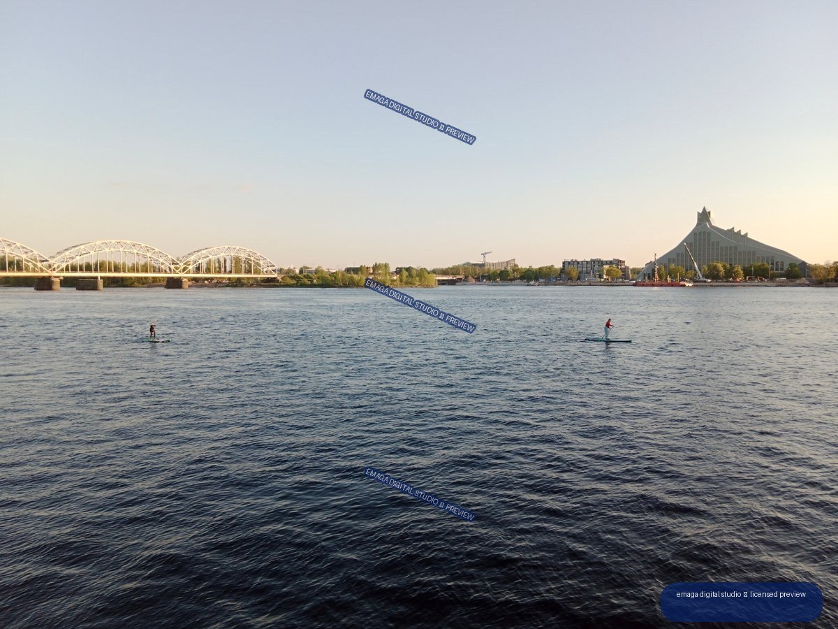 Riga, Latvia Riverside View with Bridges and Paddleboarders