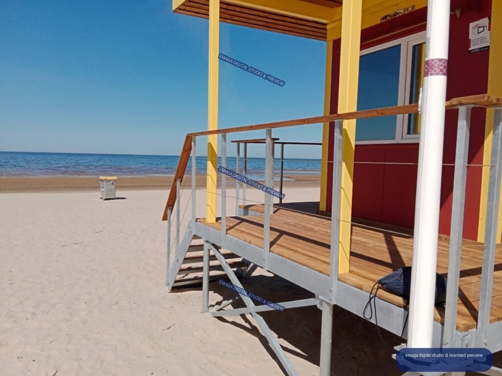 Sunny Baltic Sea beach scene with beach structure in Jurmala, Latvia