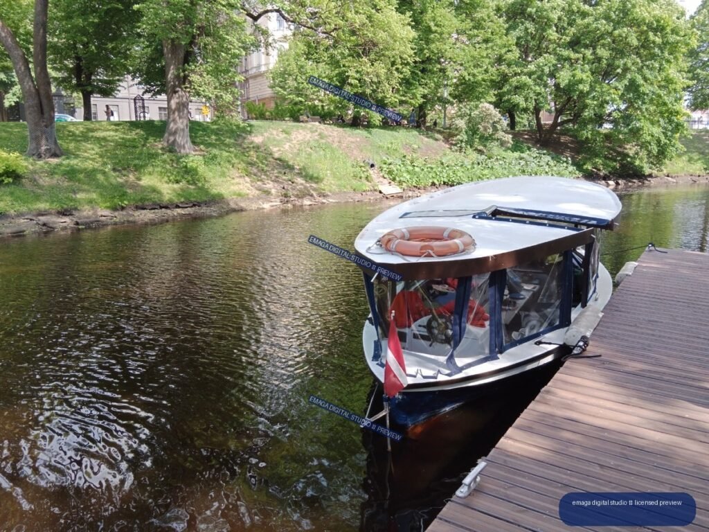 Passenger boat moored beside a park canal in Riga, Latvia