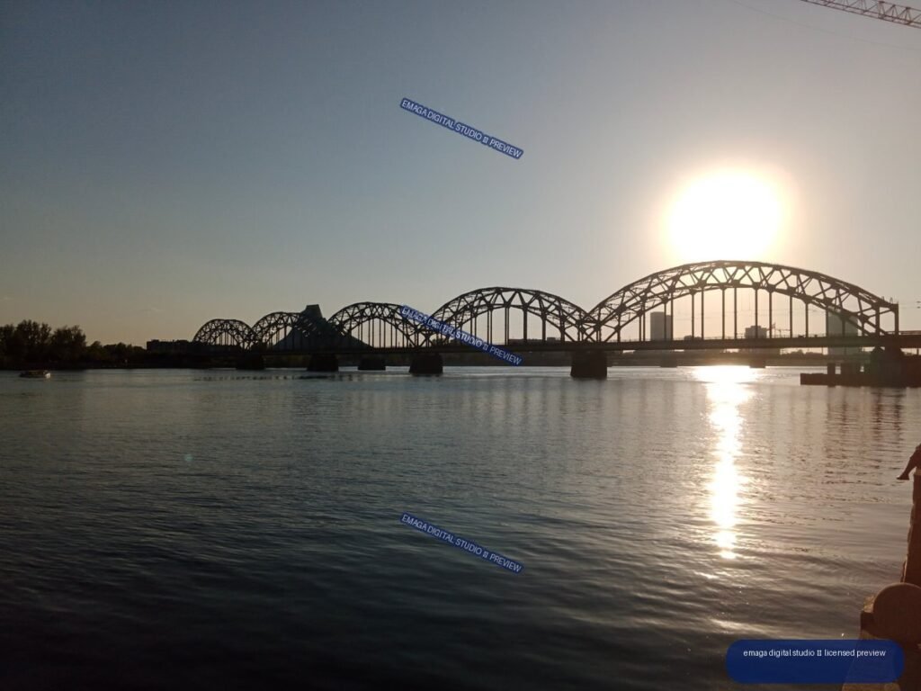 Sunset Over a Steel Arch Bridge on the Daugava in Riga, Latvia