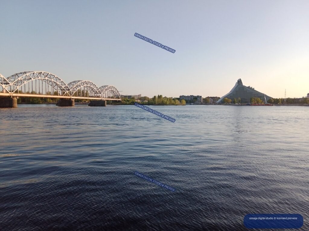 Riga, Latvia Riverside View with Arched Bridge and Modern Landmark