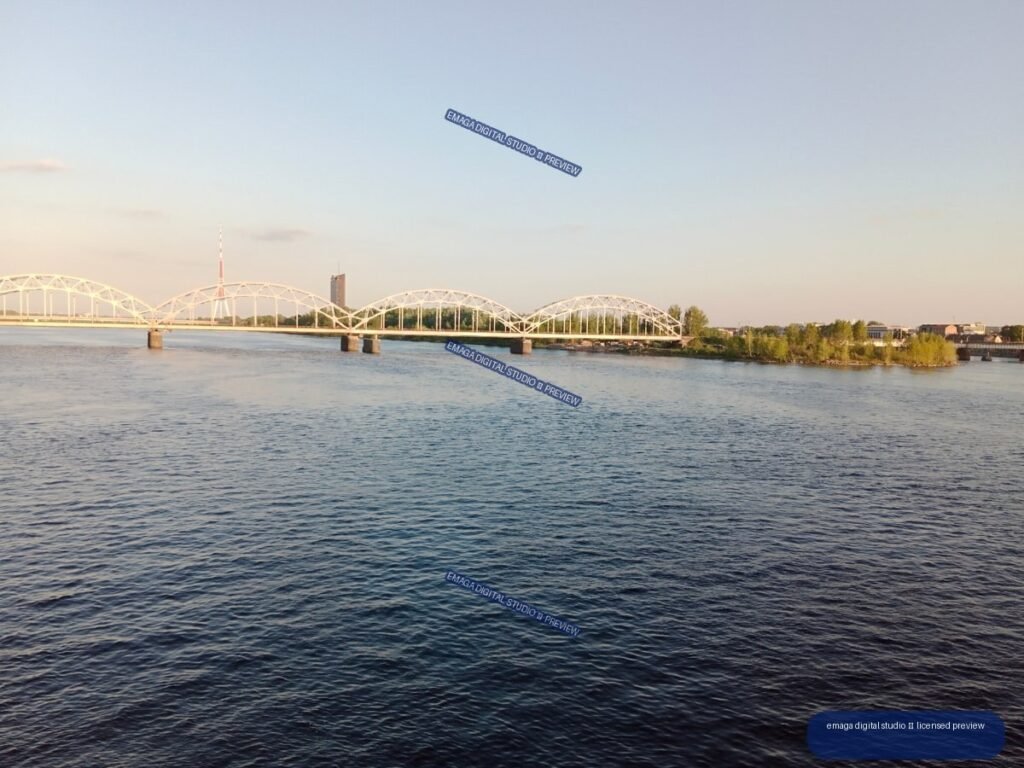 Wide River and Arched Railway Bridge in Riga, Latvia
