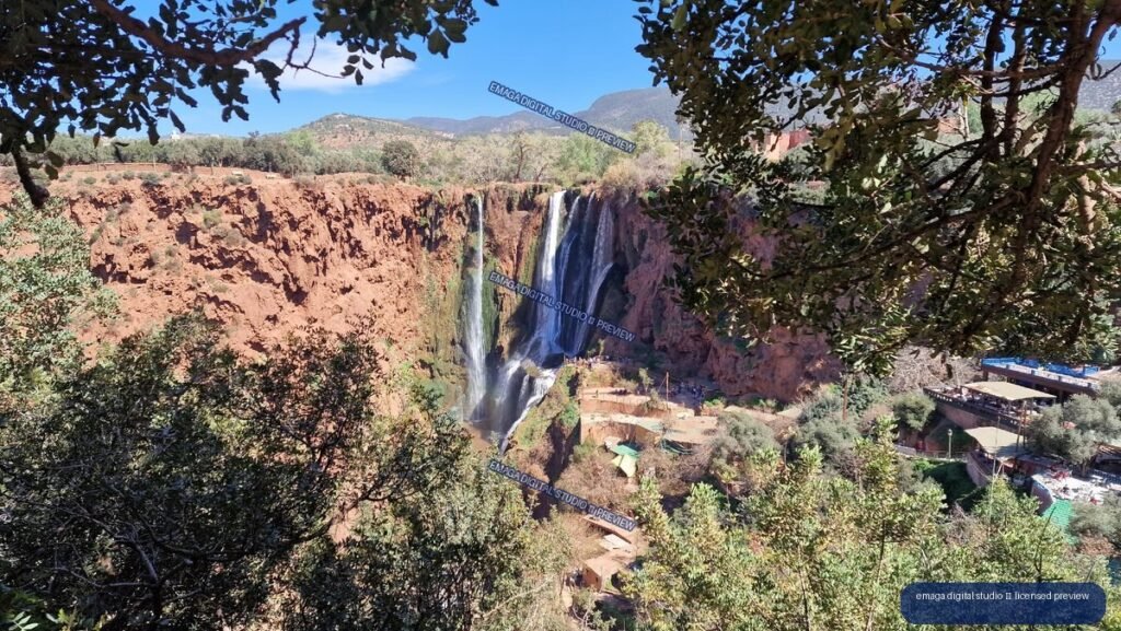 Ouzoud Waterfalls, Morocco, Framed by Trees and Red Cliffs