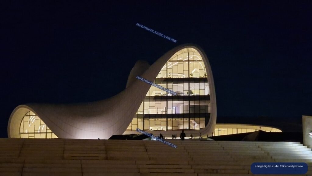 Illuminated sculptural cultural building at night in Baku, Azerbaijan