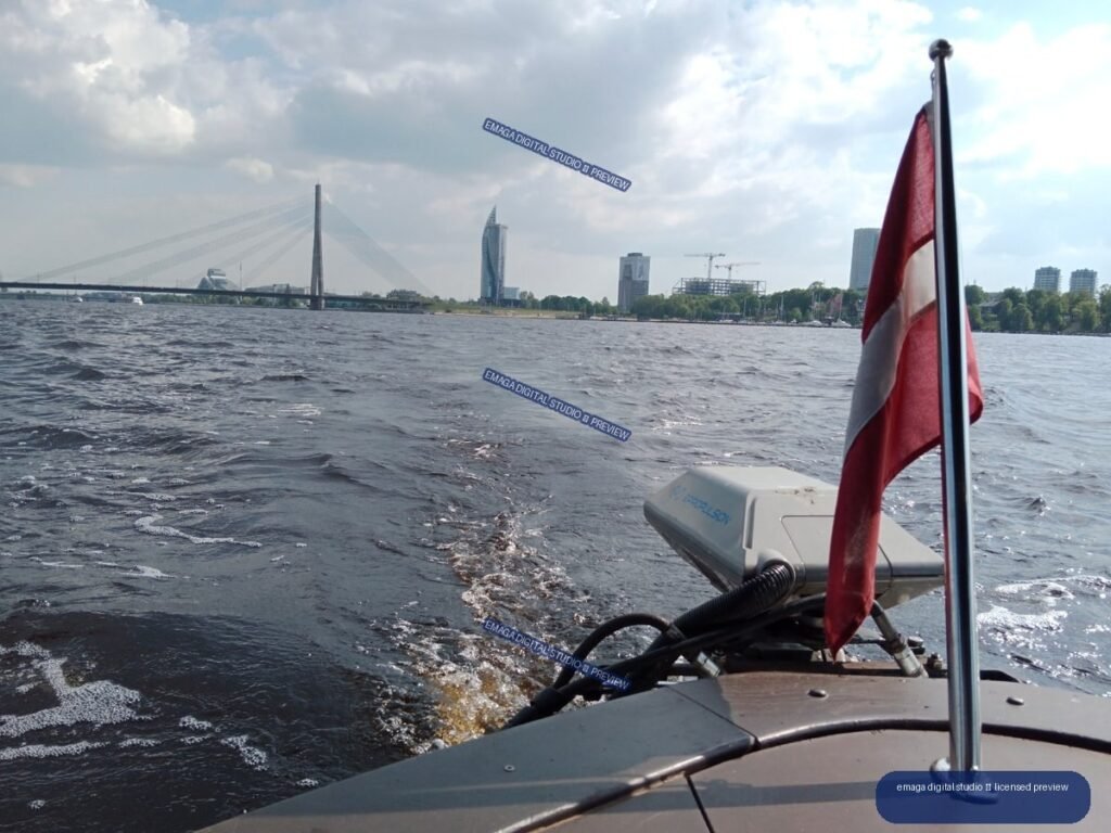 Boat on the Daugava River with Riga skyline, Latvia