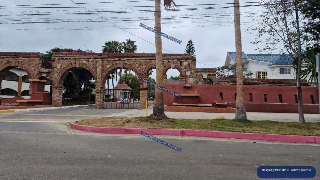Brick arched entrance and palms in Tijuana, Mexico