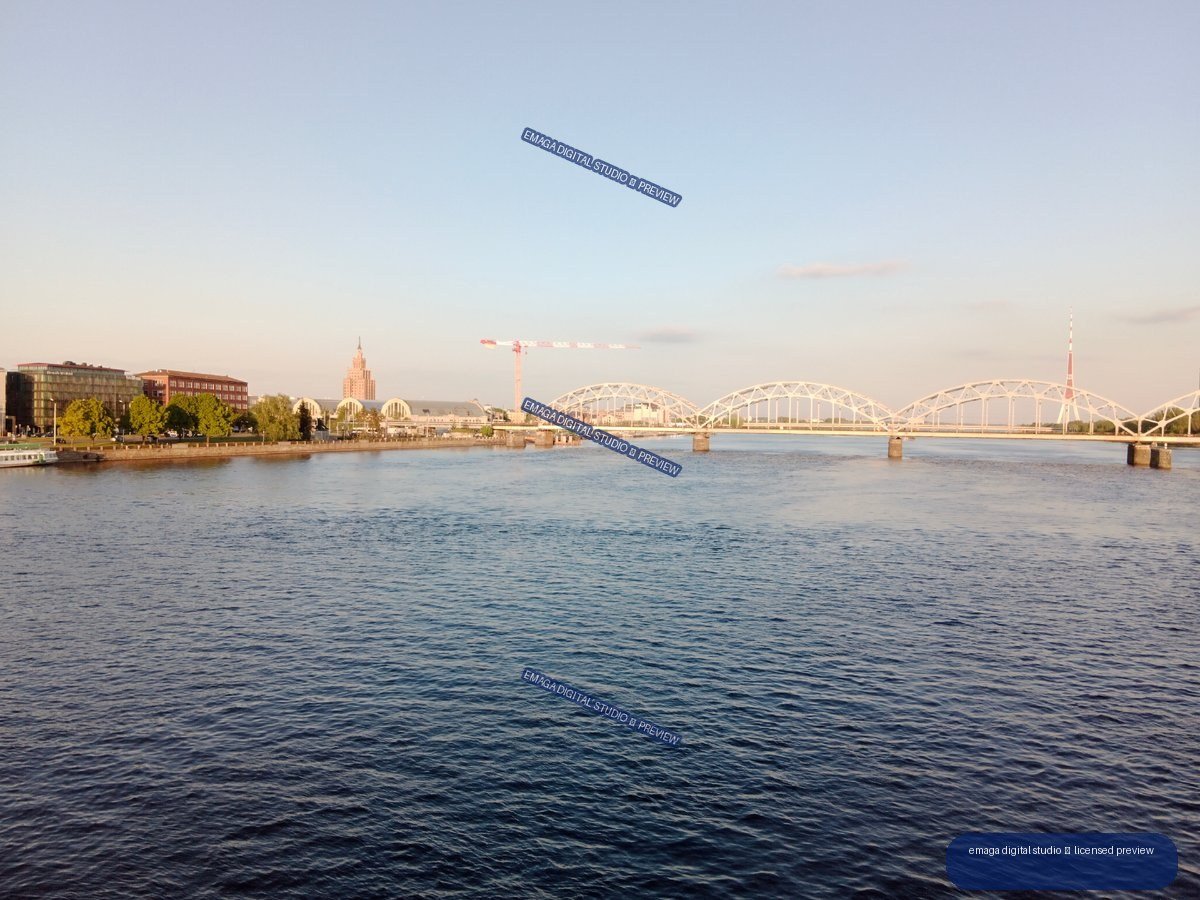 Riga, Latvia Riverfront and Arched Bridge at Golden Hour