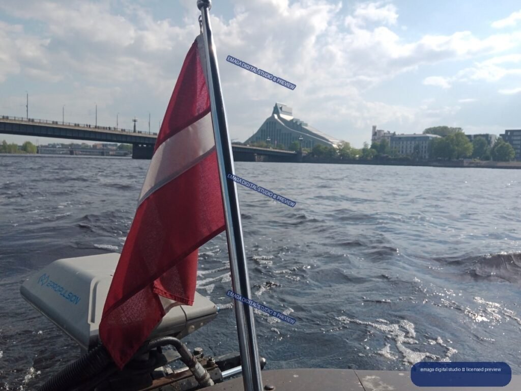 Latvian Flag on a Boat with Riga Riverfront in Latvia