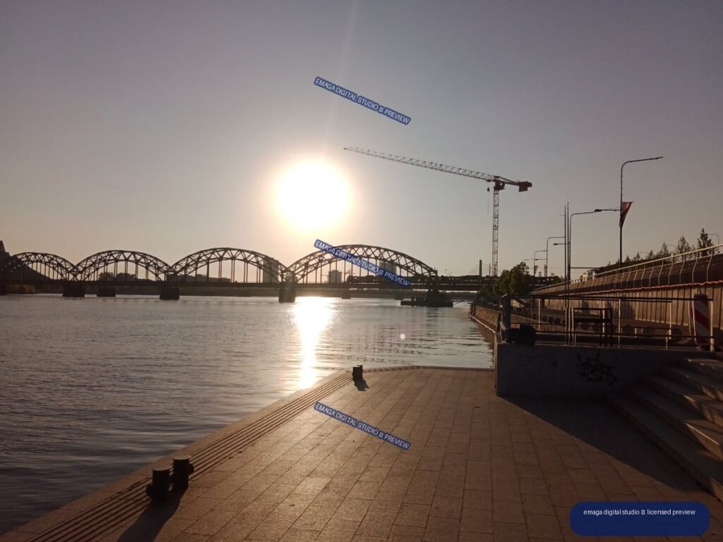 Sunset waterfront promenade and arched bridges in Riga, Latvia
