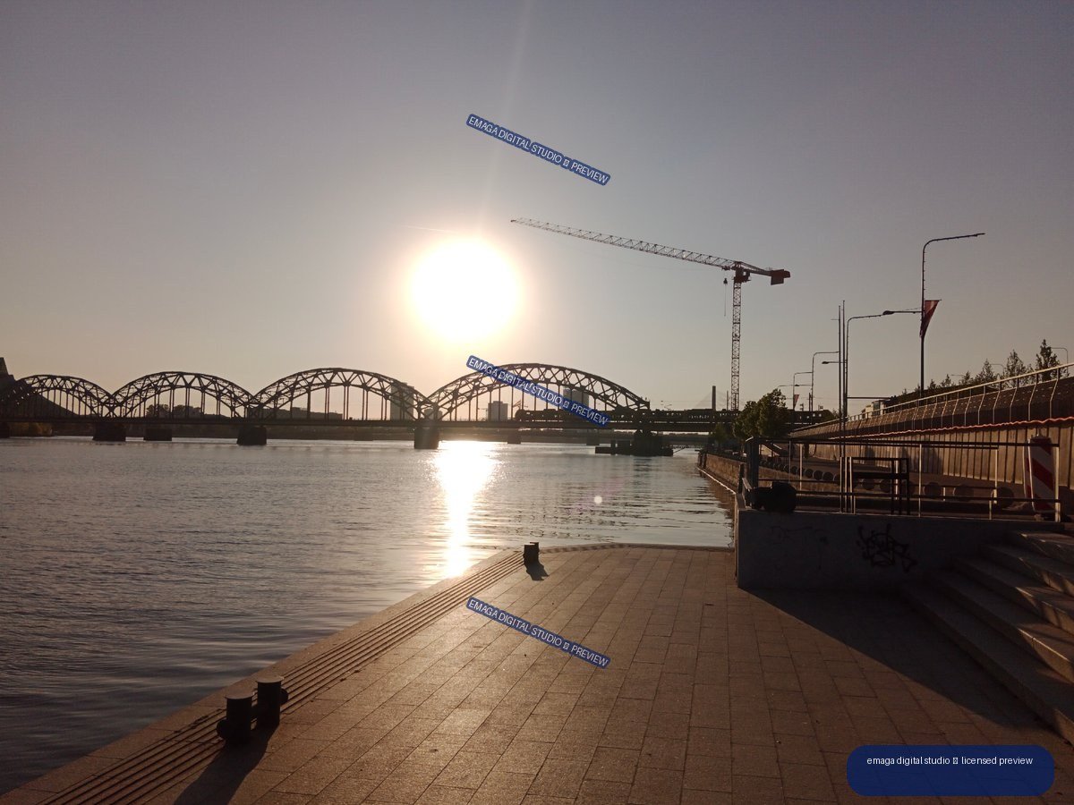 Sunset waterfront promenade and arched bridges in Riga, Latvia
