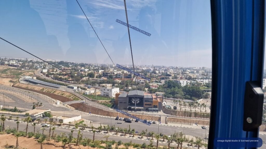 Elevated city view over Agadir, Morocco through a blue cable car window