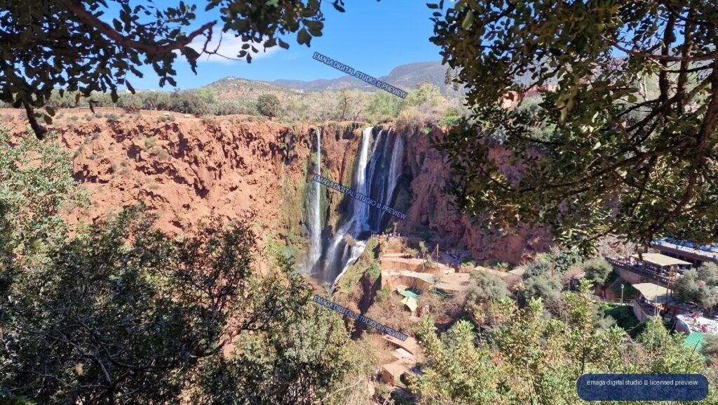 Ouzoud Waterfalls in Morocco Framed by Trees and Red Cliffs